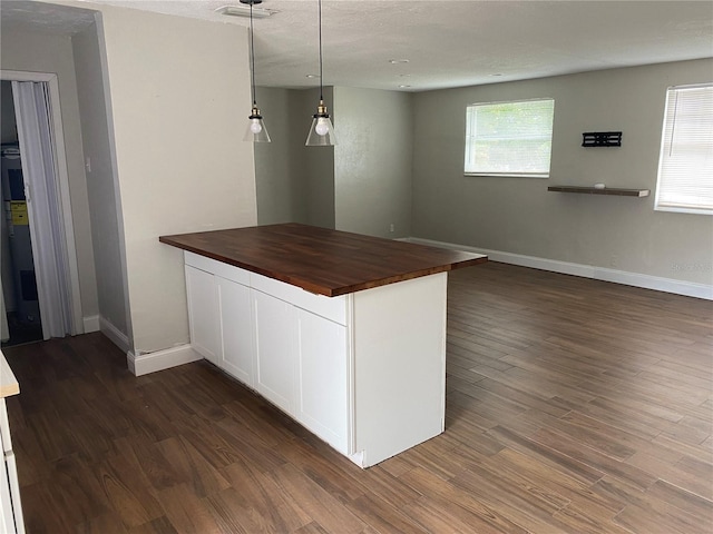 kitchen with decorative light fixtures, white cabinetry, butcher block counters, dark hardwood / wood-style flooring, and a textured ceiling