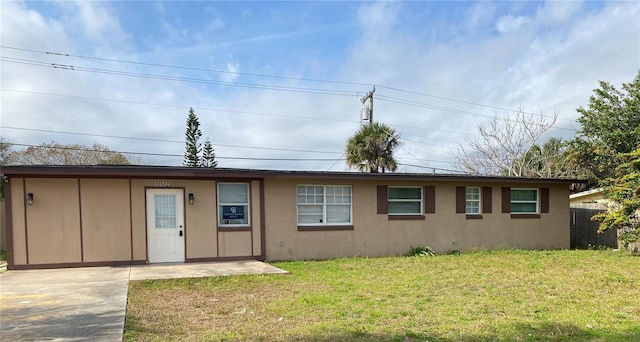 rear view of property featuring a yard