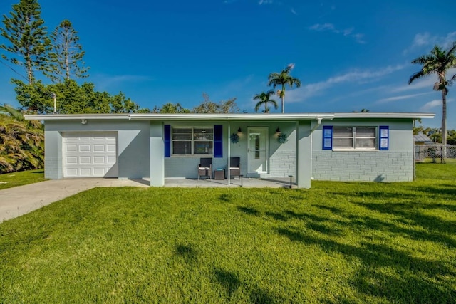 single story home with covered porch, a garage, and a front lawn