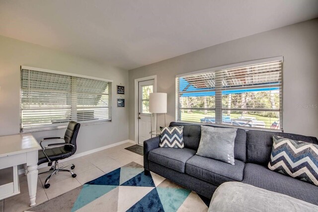 office space with a healthy amount of sunlight and light tile patterned flooring