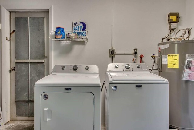 laundry area featuring separate washer and dryer and electric water heater