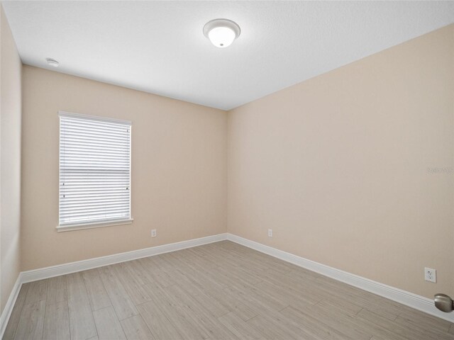 empty room with light hardwood / wood-style flooring