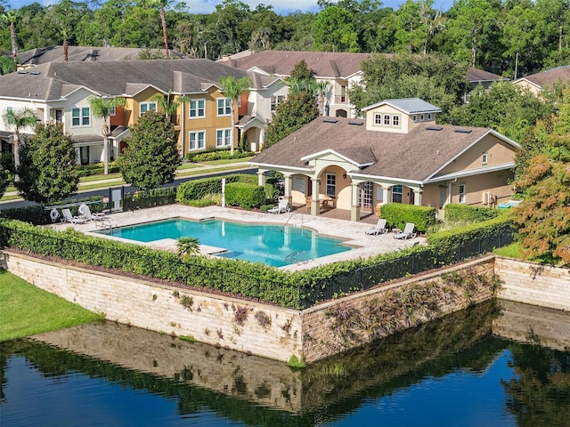 view of swimming pool with a water view