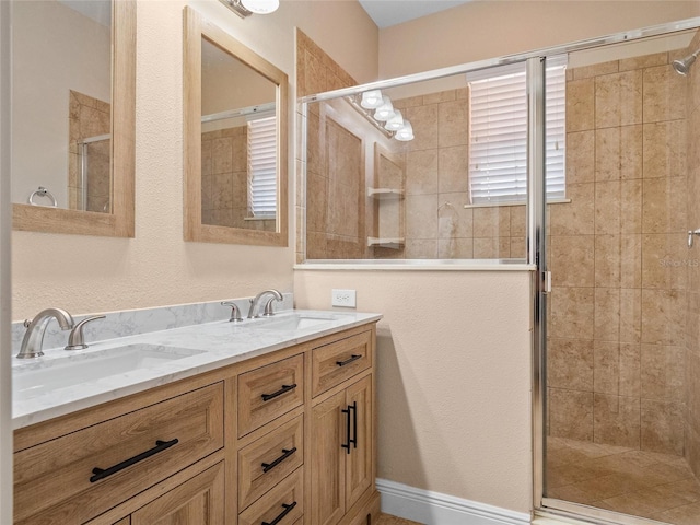 bathroom with vanity and a shower with door