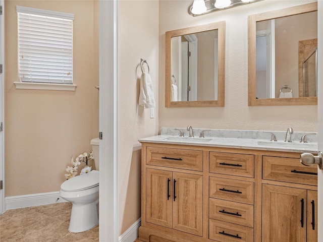 bathroom featuring tile patterned floors, a shower with door, vanity, and toilet