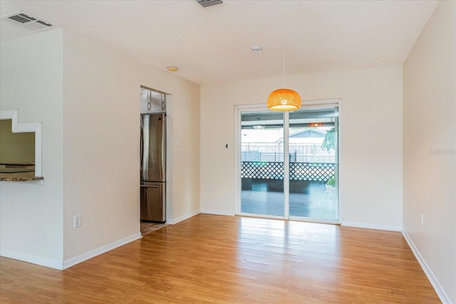 spare room with light wood-type flooring