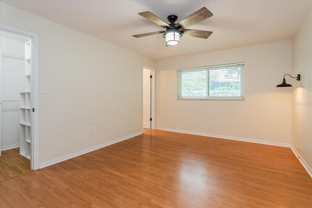 empty room featuring ceiling fan and light hardwood / wood-style flooring