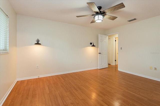 empty room with ceiling fan and hardwood / wood-style flooring