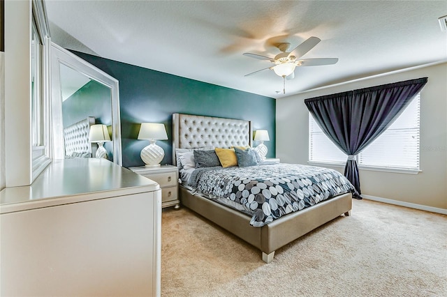 carpeted bedroom with ceiling fan and a textured ceiling