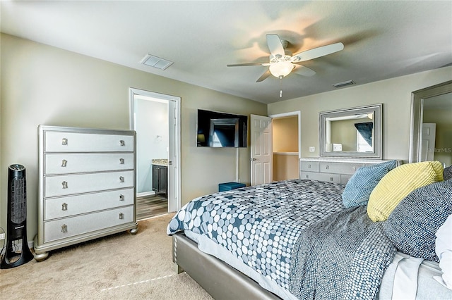 carpeted bedroom with ceiling fan and ensuite bathroom