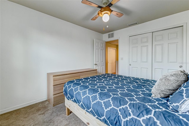 carpeted bedroom featuring ceiling fan and a closet