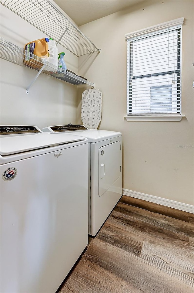 laundry area featuring washer and clothes dryer and hardwood / wood-style floors