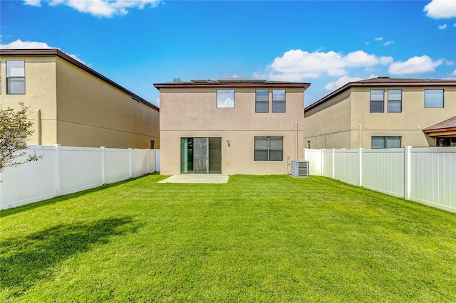 rear view of property featuring a lawn