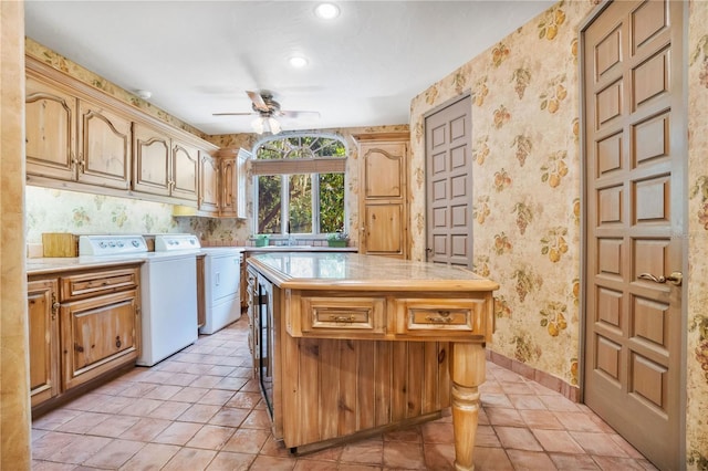 kitchen with wallpapered walls, ceiling fan, light countertops, washer and dryer, and light tile patterned flooring