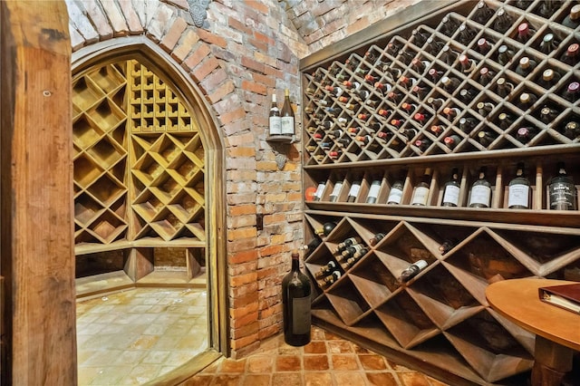 wine area featuring brick wall