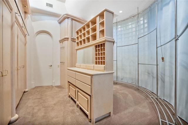 walk in closet featuring visible vents and light colored carpet