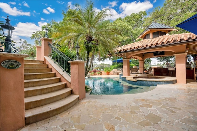 view of pool featuring stairs, a patio, a gazebo, and a pool with connected hot tub