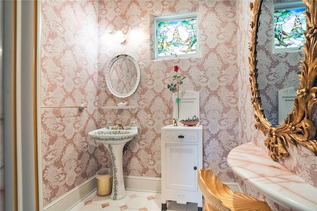 bathroom with wallpapered walls