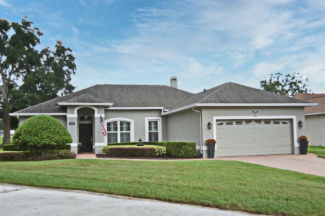 single story home with a front yard and a garage