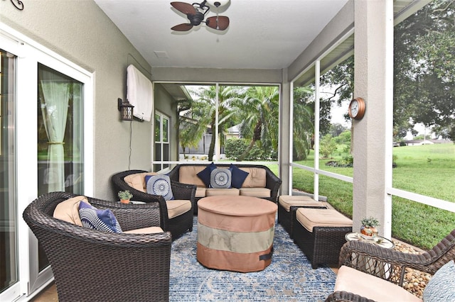 sunroom featuring ceiling fan