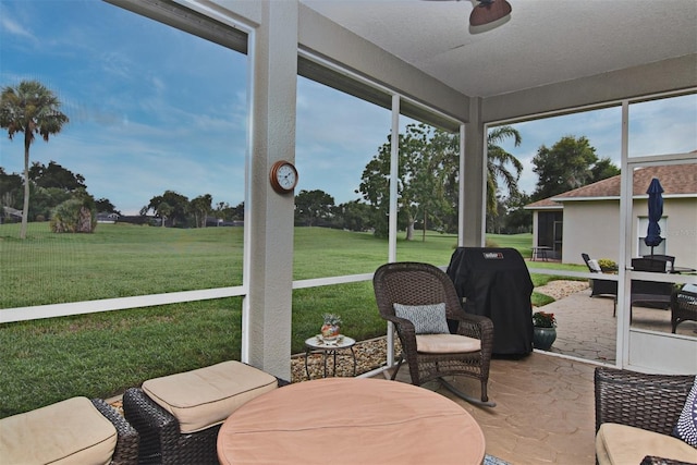 sunroom / solarium featuring ceiling fan