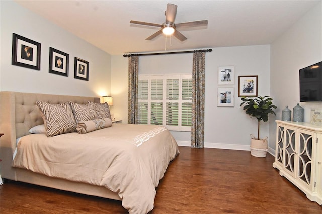 bedroom with dark hardwood / wood-style flooring and ceiling fan