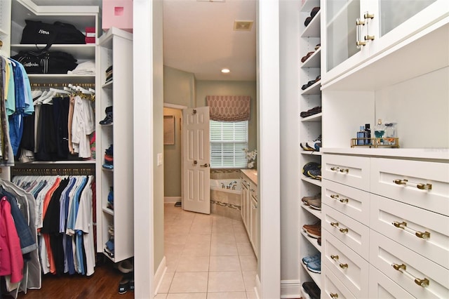 spacious closet featuring light tile patterned floors