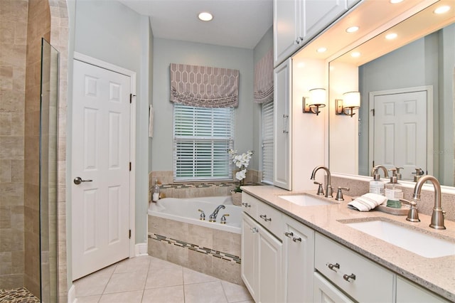 bathroom with plus walk in shower, tile patterned flooring, and vanity