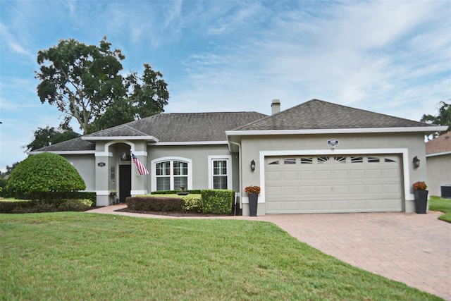 view of front of house with a garage and a front yard