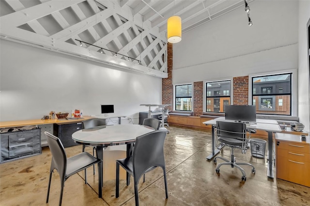 dining area with high vaulted ceiling, rail lighting, and beamed ceiling