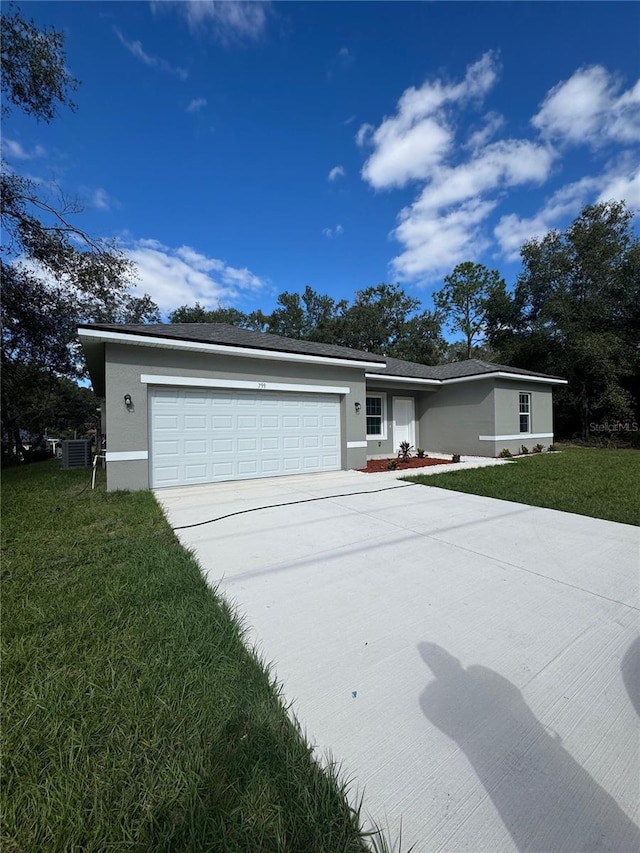 single story home with a garage, central air condition unit, and a front lawn