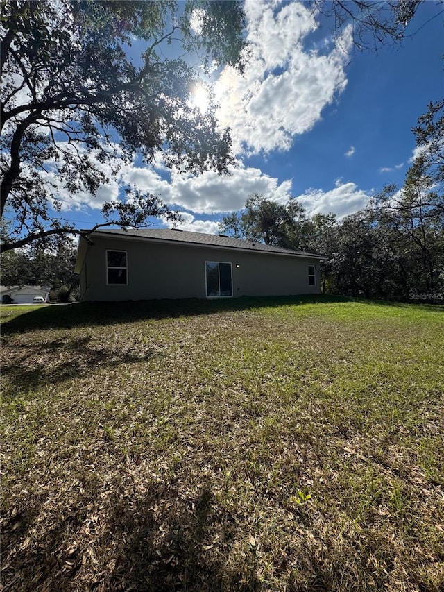 back of property with a yard