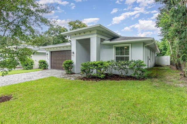 view of front of property with a front yard and a garage