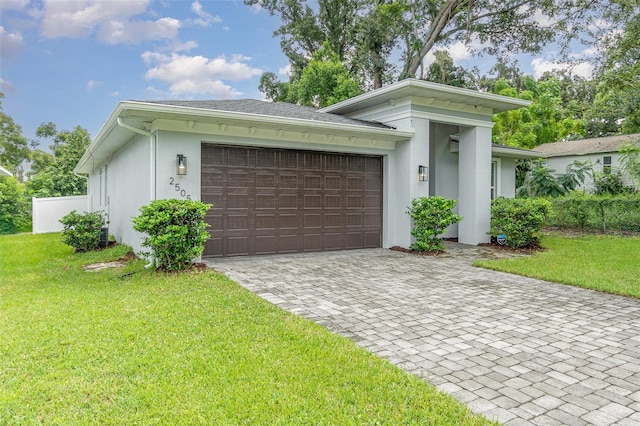 view of front of property with a front yard and a garage