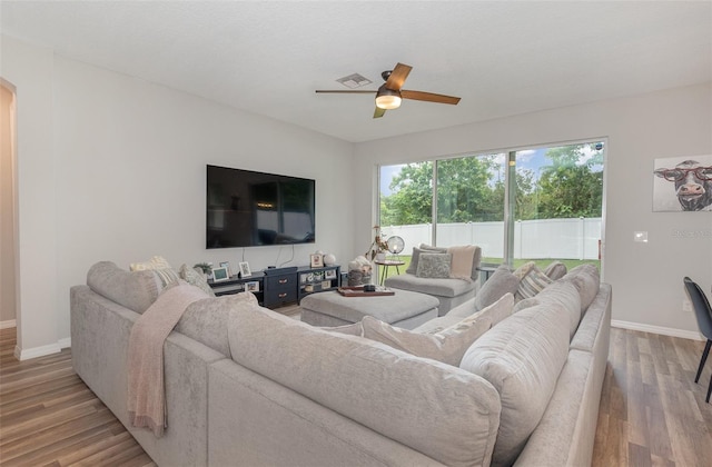 living room featuring ceiling fan and light hardwood / wood-style flooring