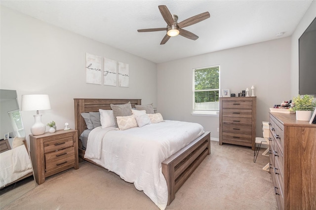 bedroom featuring light colored carpet and ceiling fan