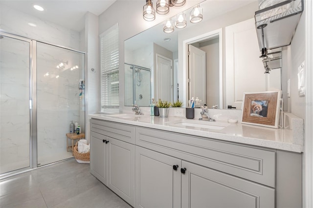 bathroom featuring vanity, a chandelier, an enclosed shower, and tile patterned floors