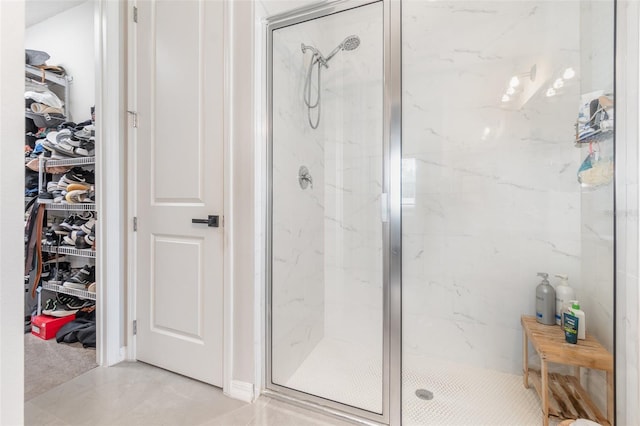 bathroom with an enclosed shower and tile patterned floors