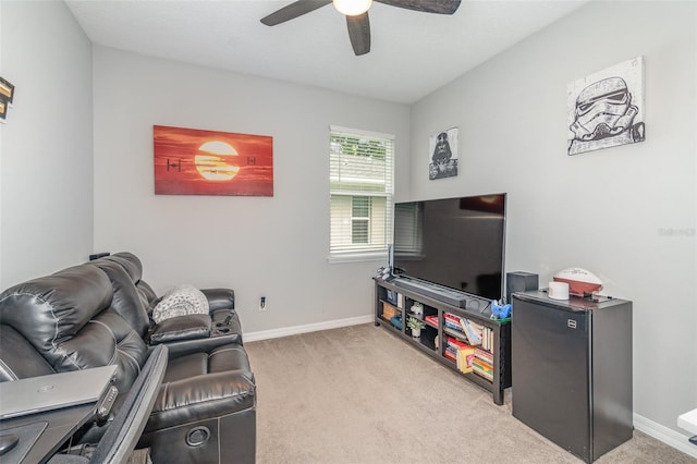 carpeted living room with ceiling fan