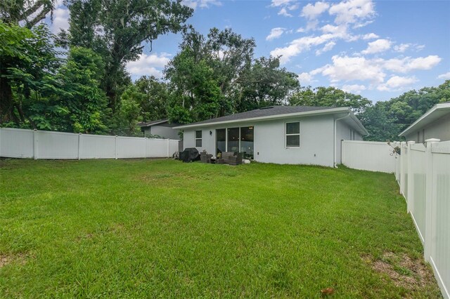 rear view of house with a lawn