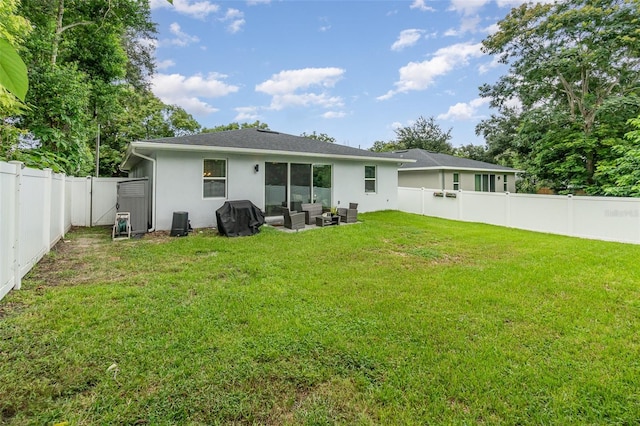 rear view of house with a lawn, an outdoor hangout area, and a patio area