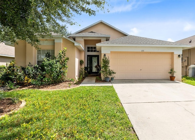 single story home with a front yard and a garage