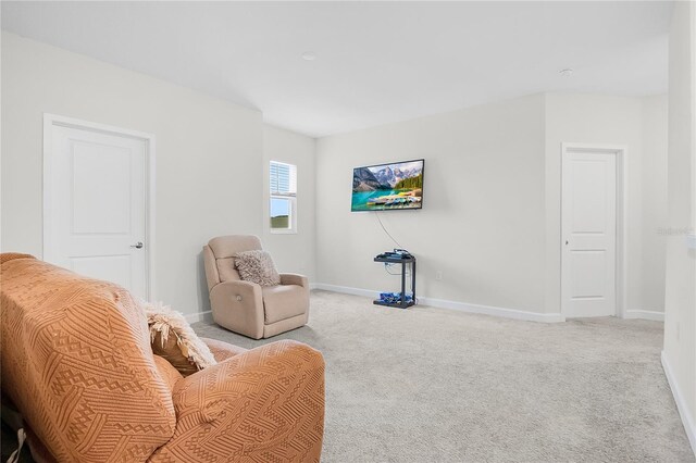 living area with light colored carpet