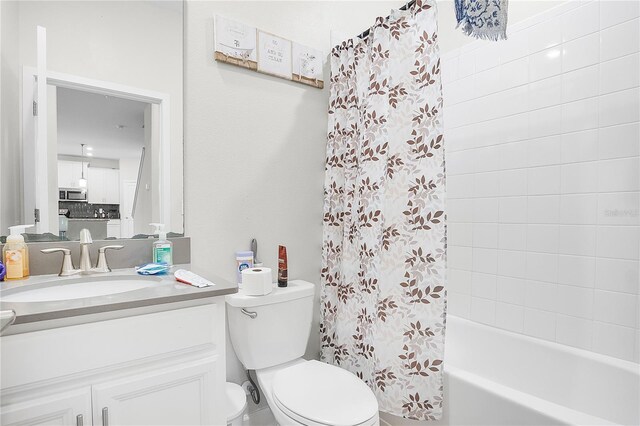 full bathroom featuring shower / bath combo, toilet, and vanity