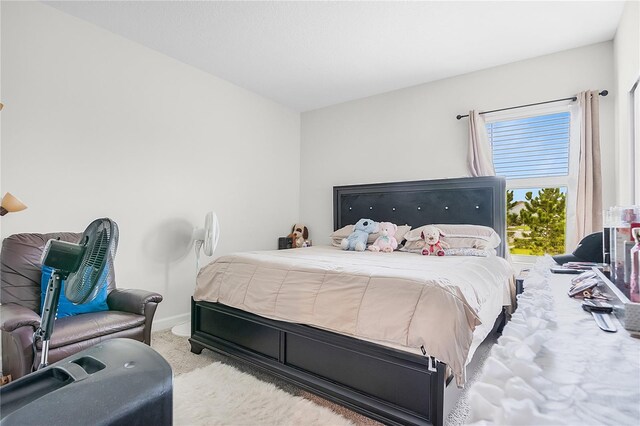 bedroom featuring light colored carpet