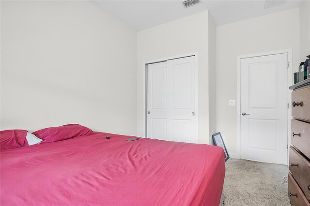 carpeted bedroom with a closet