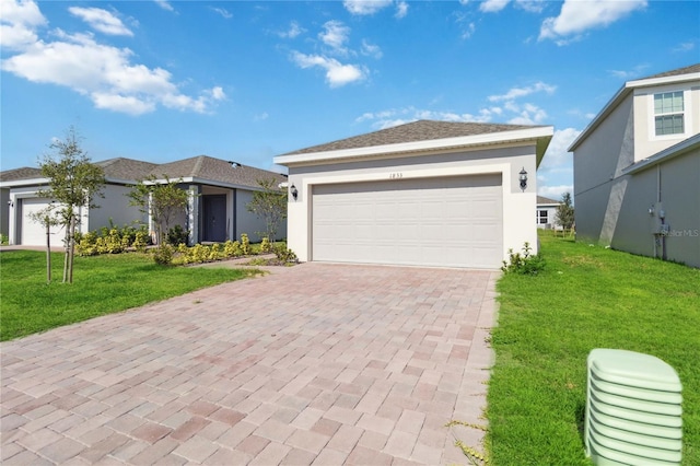 view of front of property with a front yard and a garage