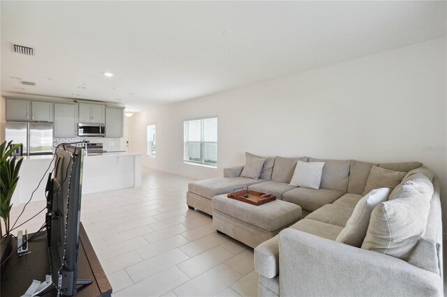 living room with light tile patterned flooring