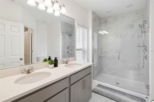 bathroom featuring vanity, toilet, an enclosed shower, and tile patterned floors