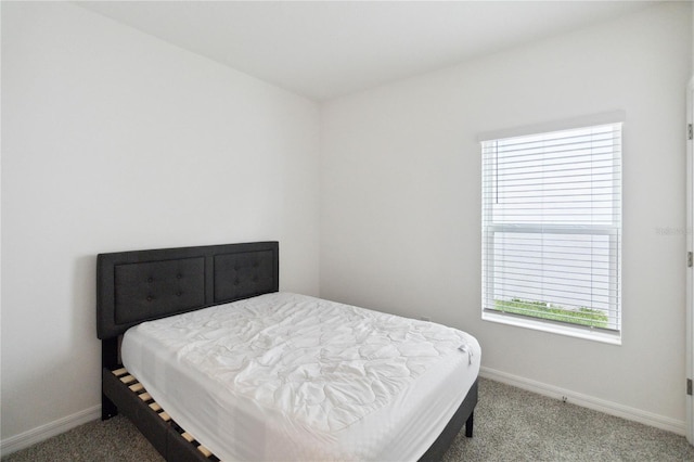 bedroom featuring multiple windows and light colored carpet